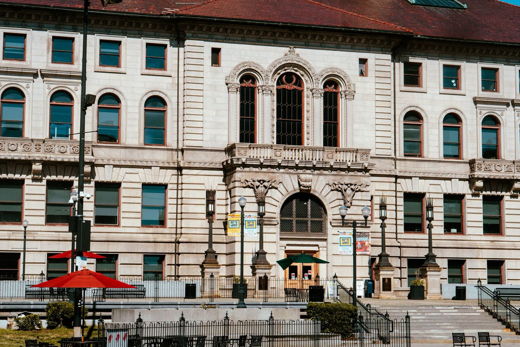 Arched windows and carved stone on the facade of a civic building.